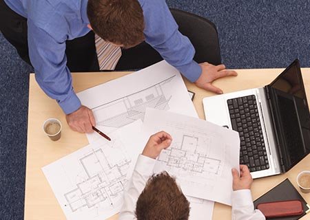 Project Management men holding blueprints
